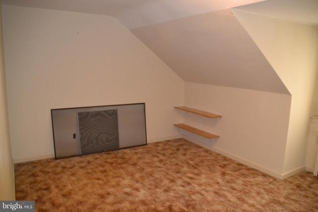 bonus room with lofted ceiling and carpet floors