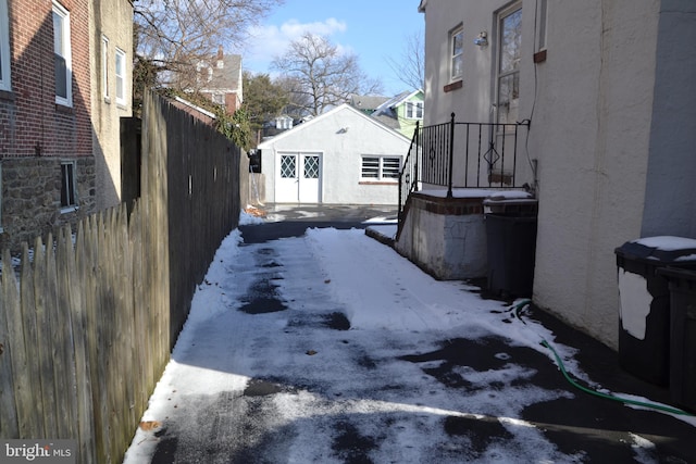 yard covered in snow featuring an outbuilding