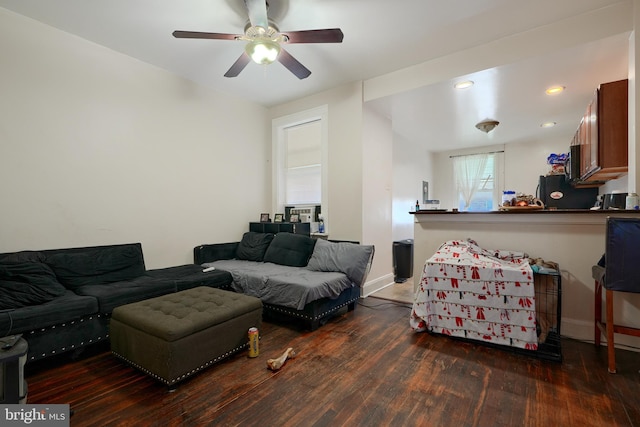 living room with dark hardwood / wood-style floors and ceiling fan