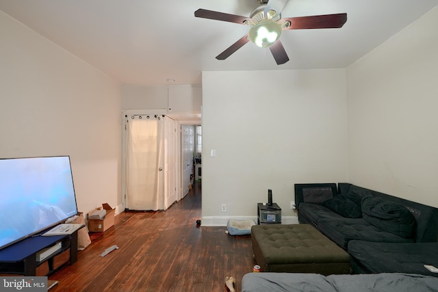 living room featuring dark hardwood / wood-style floors and ceiling fan