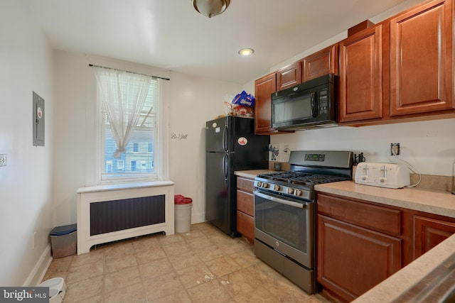 kitchen with electric panel, radiator, and black appliances