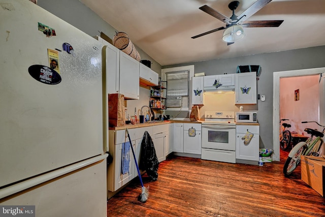 kitchen with white appliances, ceiling fan, dark wood-type flooring, sink, and white cabinetry