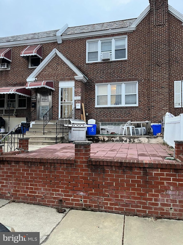 rear view of property with cooling unit