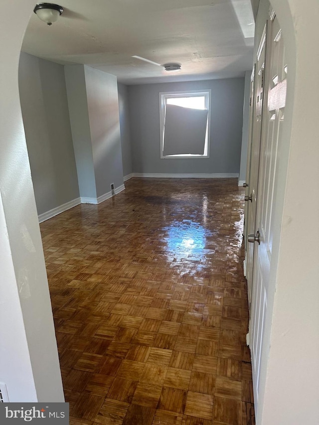 empty room with dark parquet floors