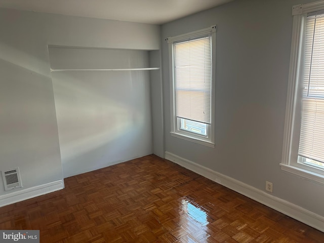 empty room featuring dark parquet flooring