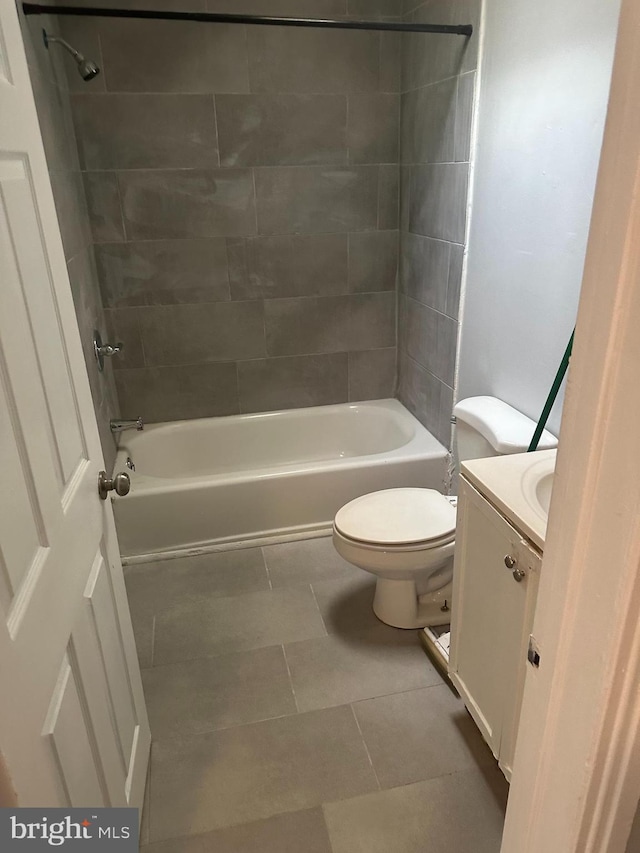 full bathroom with tile patterned floors, vanity, toilet, and tiled shower / bath