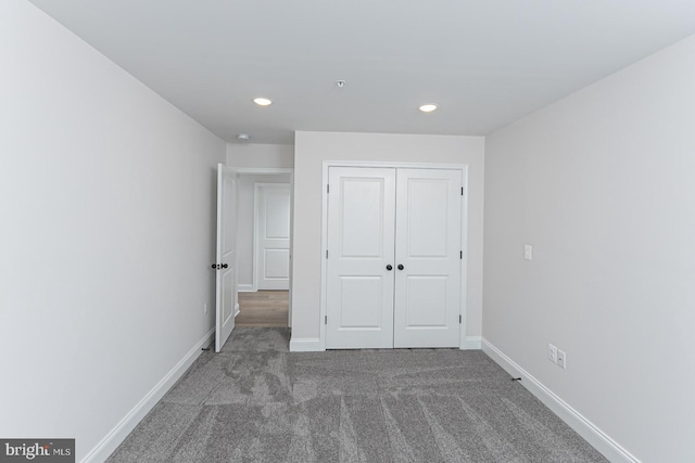 unfurnished bedroom with carpet flooring and a closet