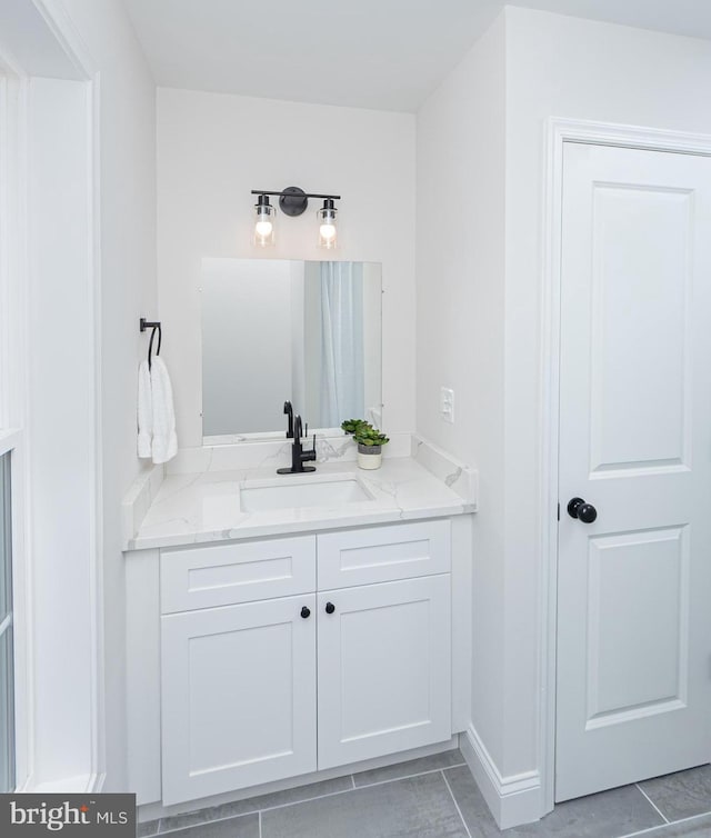 bathroom featuring tile patterned flooring and vanity