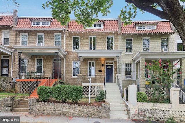 view of front of home with cooling unit and a porch