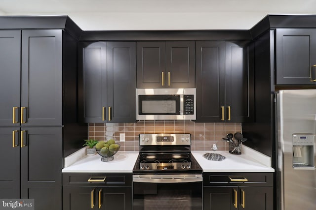 kitchen with stainless steel appliances and tasteful backsplash