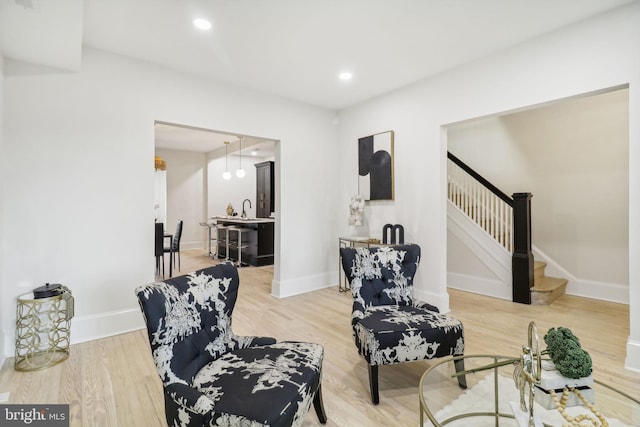 living room featuring hardwood / wood-style floors and sink