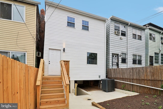 back of property featuring central AC and cooling unit