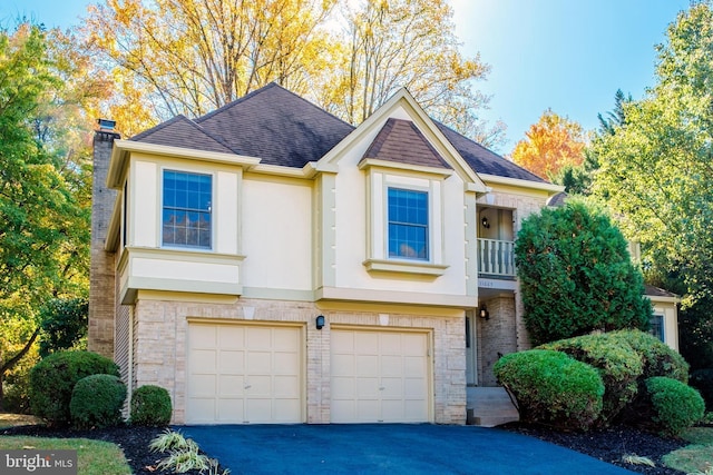 view of front of house with a garage and a balcony