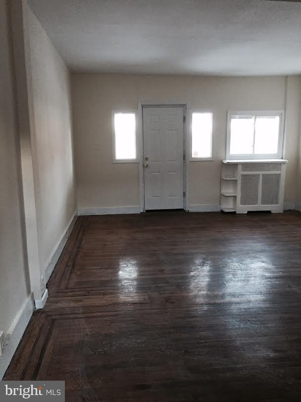 entrance foyer featuring a wealth of natural light and dark hardwood / wood-style floors