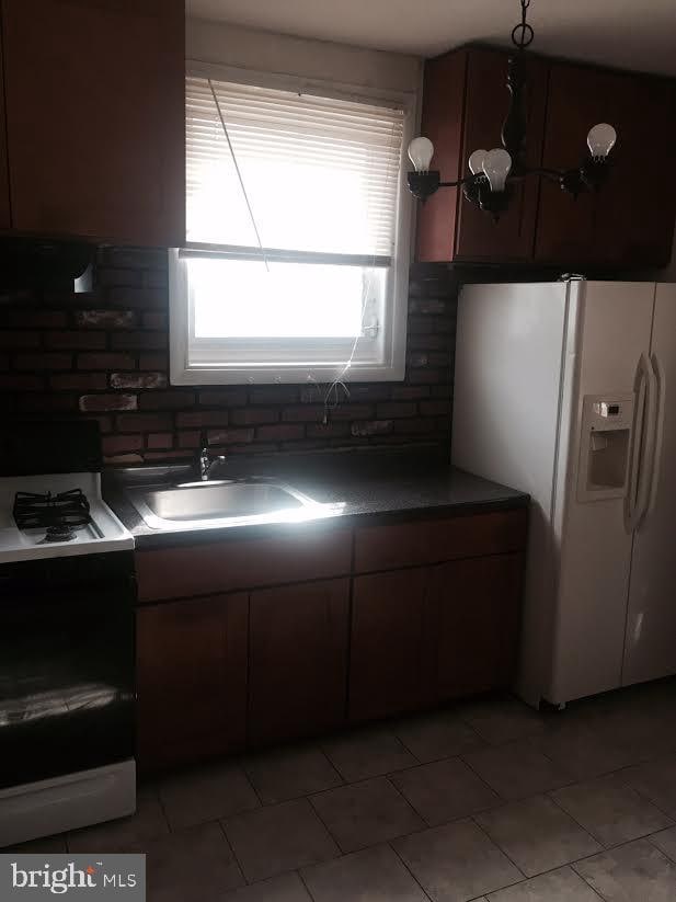 kitchen with white appliances and sink