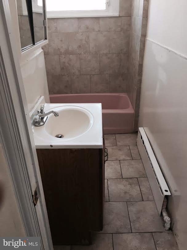 bathroom with baseboard heating, tile patterned floors, and vanity