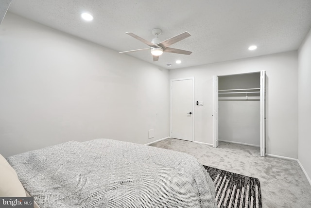 bedroom with a closet, light colored carpet, and ceiling fan