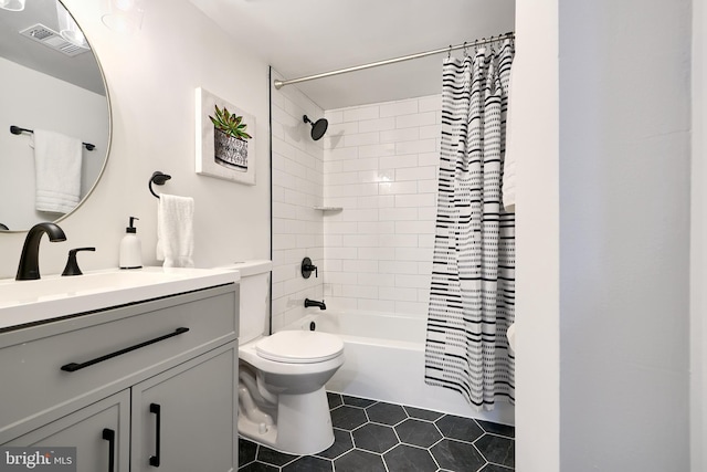 full bathroom with tile patterned flooring, shower / tub combo with curtain, vanity, and toilet