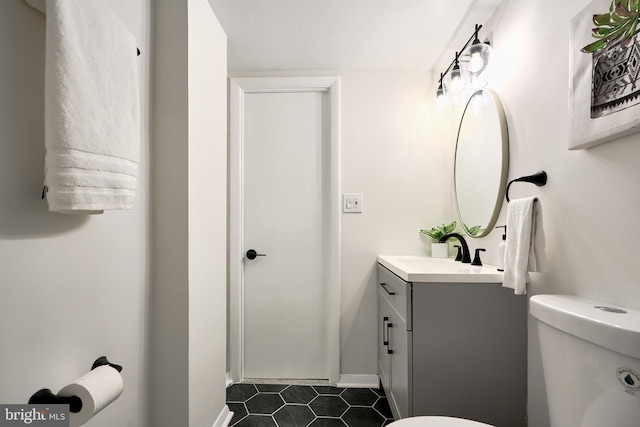 bathroom with tile patterned floors, vanity, and toilet