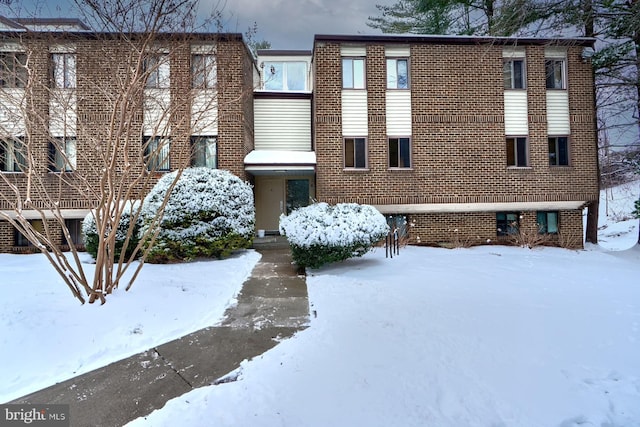 snow covered property featuring cooling unit