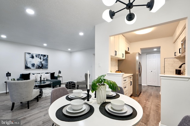 dining space with hardwood / wood-style flooring