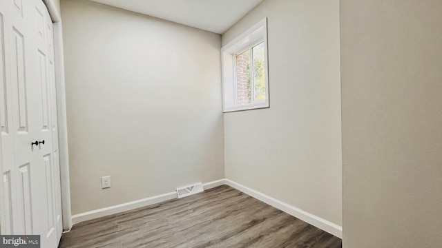 unfurnished room featuring wood-type flooring