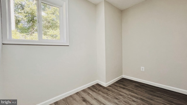 unfurnished room featuring dark hardwood / wood-style floors