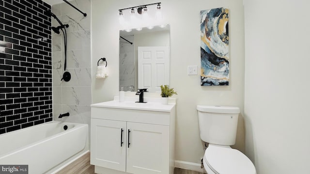 full bathroom featuring toilet, tiled shower / bath combo, and vanity