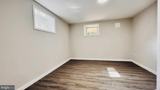 unfurnished room with hardwood / wood-style flooring