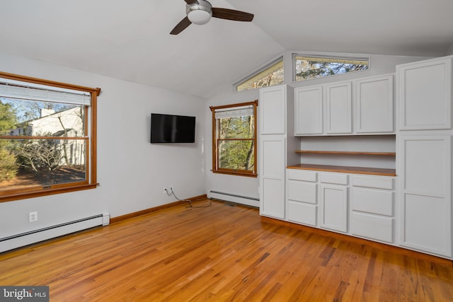 unfurnished living room featuring ceiling fan, lofted ceiling, light wood-type flooring, and a baseboard heating unit