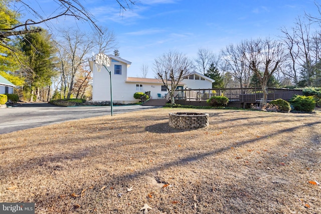 exterior space with a fire pit and a wooden deck