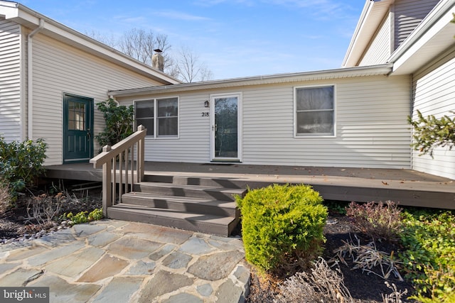 view of exterior entry with a deck