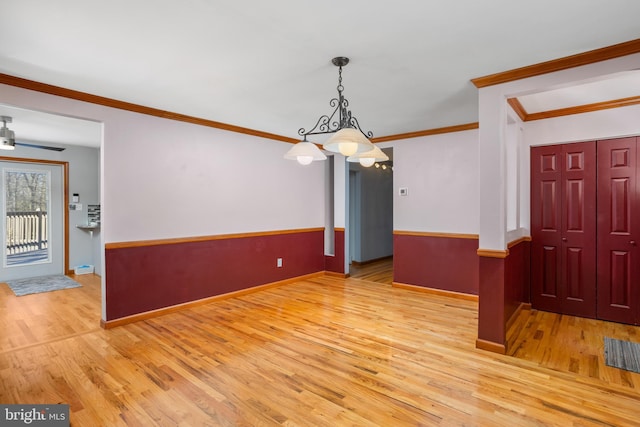 unfurnished dining area with light hardwood / wood-style flooring, ceiling fan, and ornamental molding