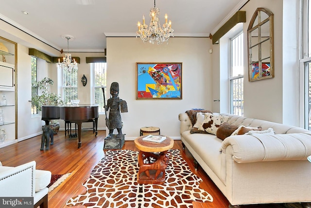 living room featuring hardwood / wood-style floors, crown molding, and a notable chandelier