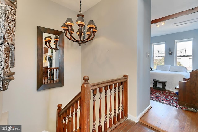 hallway featuring a chandelier and hardwood / wood-style flooring