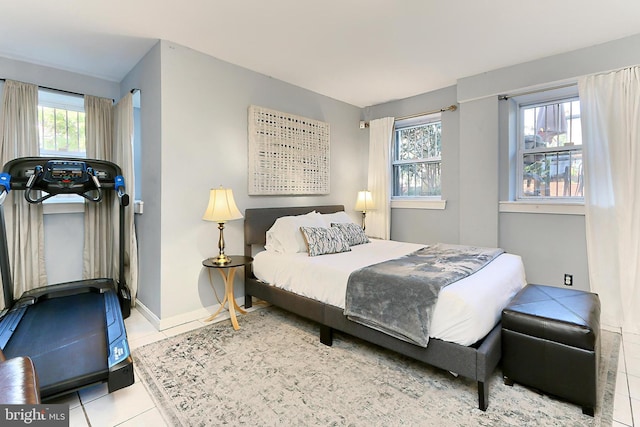 bedroom with light tile patterned flooring and multiple windows