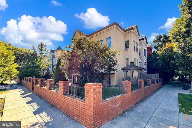 view of property exterior with a gazebo