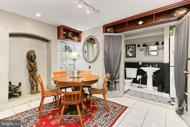 dining room with light tile patterned floors and track lighting