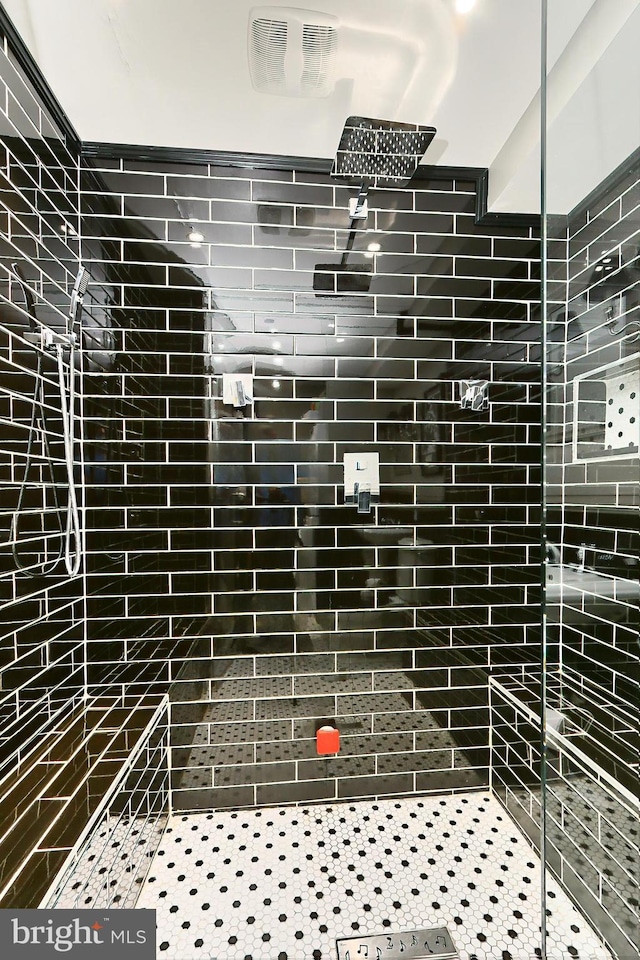 bathroom featuring a tile shower and tile patterned floors