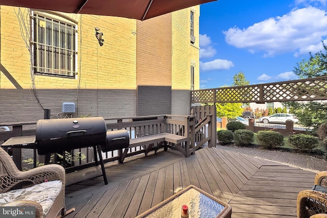 wooden terrace featuring area for grilling