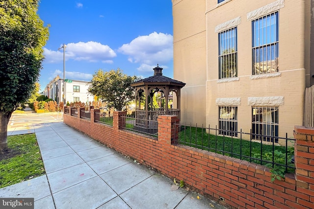 view of side of property featuring a gazebo