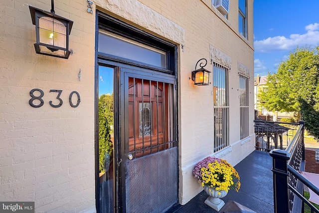 view of exterior entry with a porch