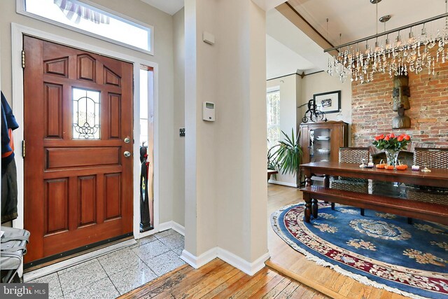 entrance foyer with light wood-type flooring and an inviting chandelier