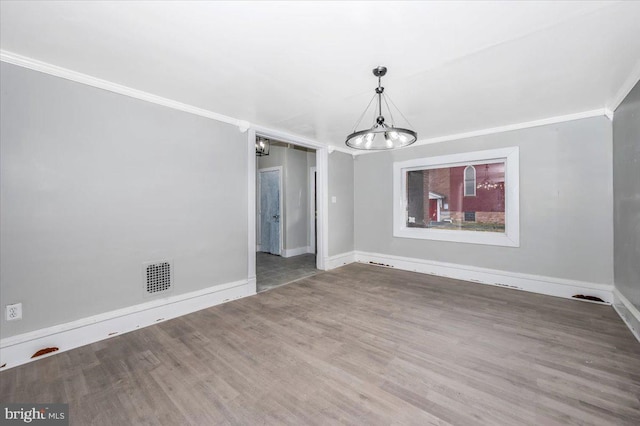 unfurnished dining area with a chandelier, hardwood / wood-style flooring, and crown molding
