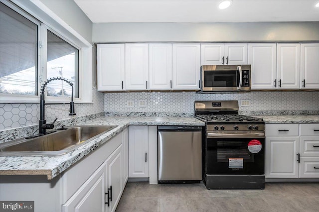 kitchen featuring white cabinetry, sink, and stainless steel appliances