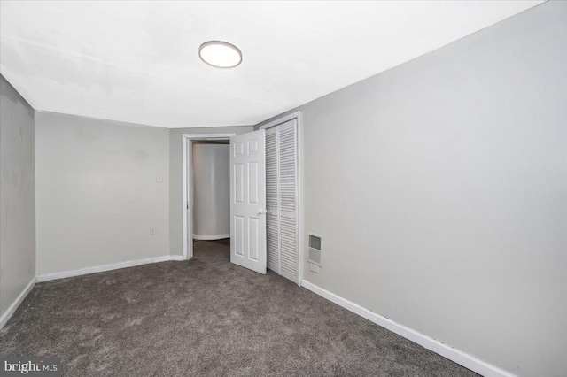 unfurnished bedroom with dark colored carpet