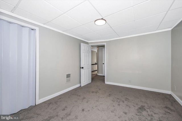 interior space featuring a drop ceiling and ornamental molding