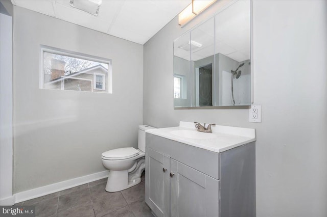 bathroom featuring tile patterned flooring, vanity, and toilet