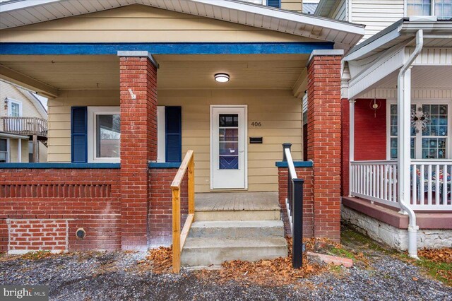 view of exterior entry with covered porch
