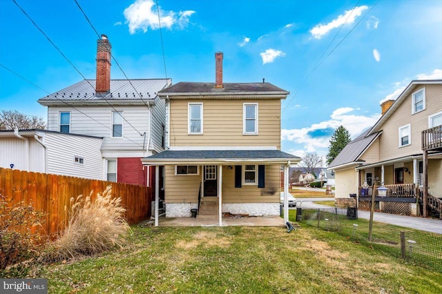 rear view of house with a yard